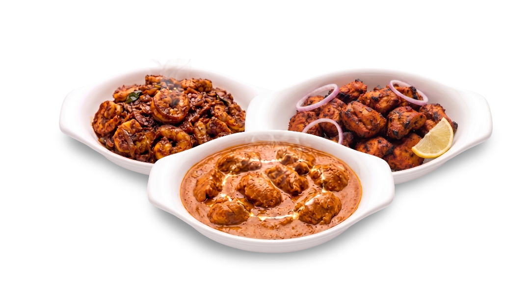 Three bowls containing butter chicken, prawns roast, and chicken tandoori served at Al Maseera Cafeteria.